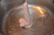 Dildo s prísavkou a semenníkmi Silicone (18 cm), pod prúdom vody